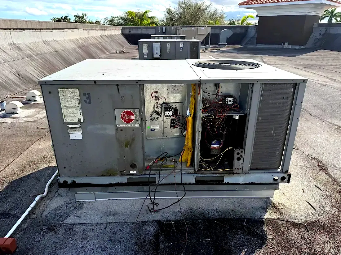 Open Rheem unit on a roof