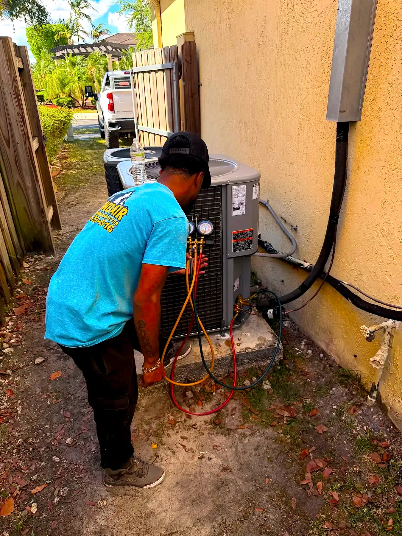 Divino Air tech checking pressures on a condenser